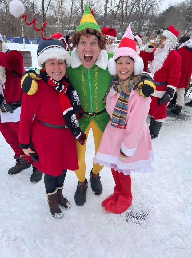 Buddy the Elf with two festive riders in the snow