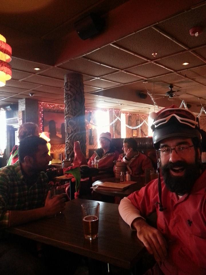 Early Santa riders sharing a moment at a brewery